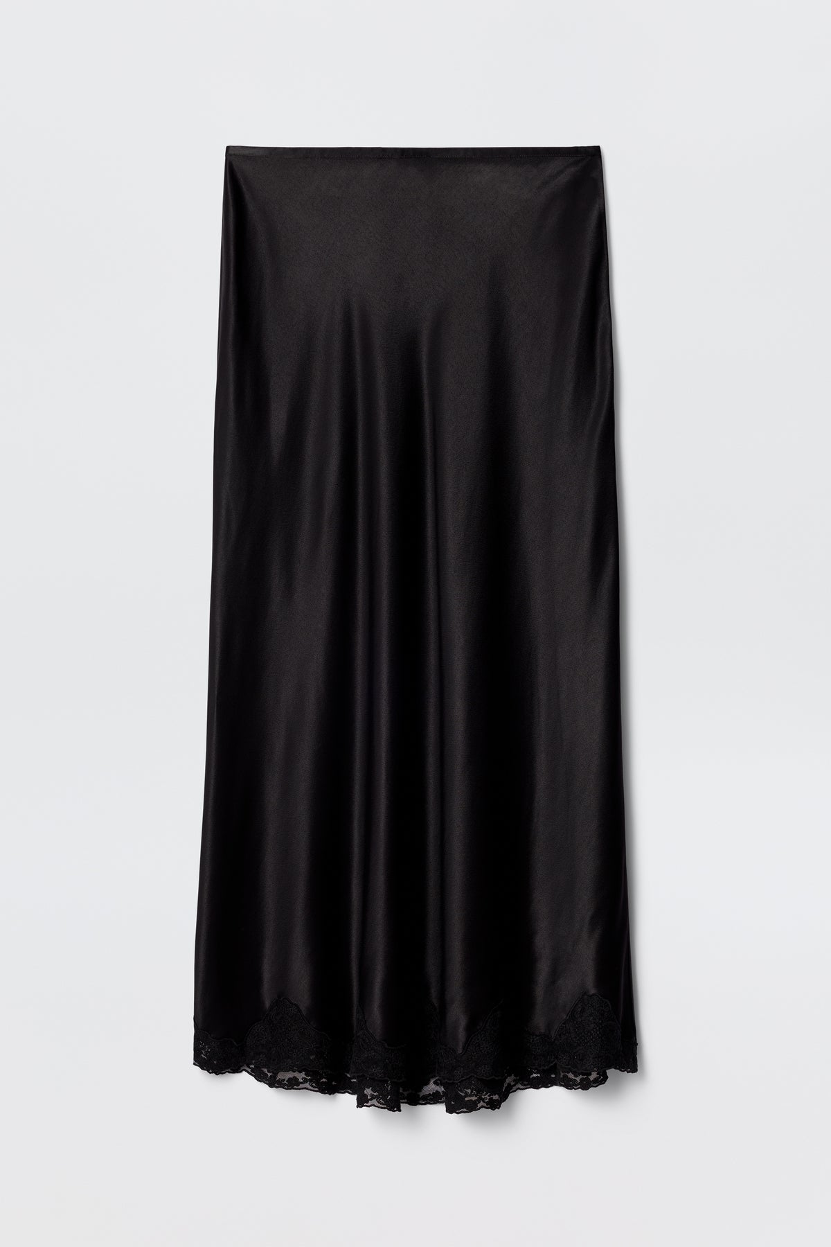 The Crystal - Black is a black satin bias-cut midi skirt with a slight sheen and delicate lace trim at the hem, displayed flat on a plain white background.