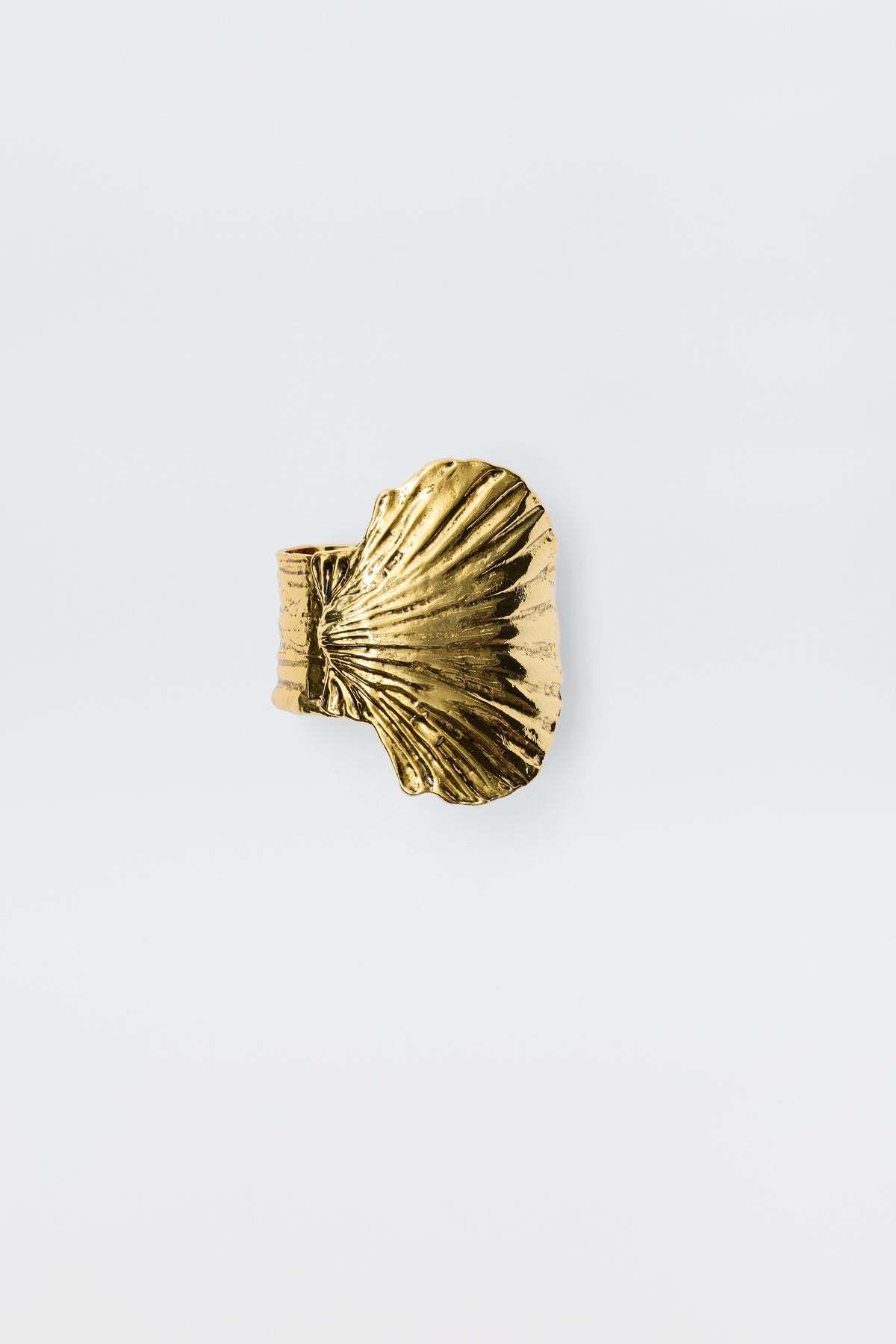 Salene - Gold is a gold ring featuring a textured, fan-shaped shell design, beautifully embodying the essence of shell jewellery on a plain white background.