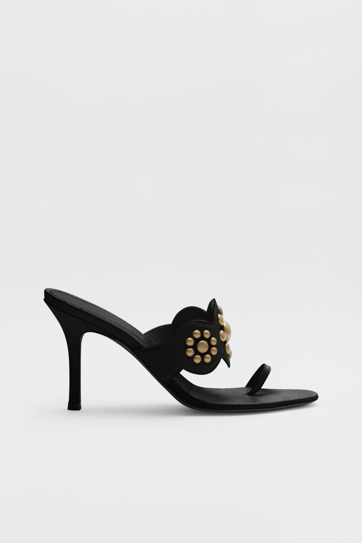 Esmeray - Black high-heeled sandal featuring a thin heel, open toe, and gold stud embellishments on the upper strap, displayed against a plain white background.