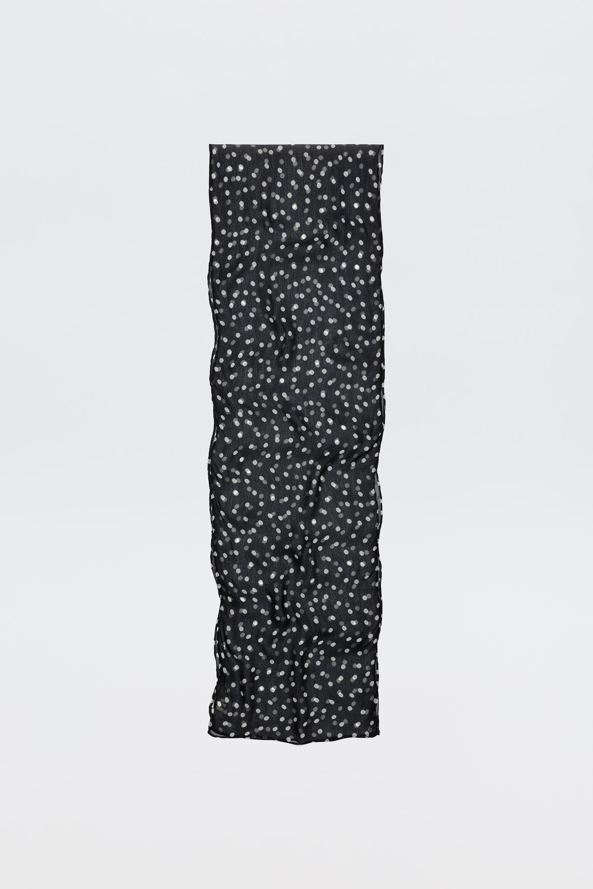 The Julien - Emma Spot Deep Navy scarf is long and black with a soft, quilted texture and small white floral spots, shown against a plain white background.