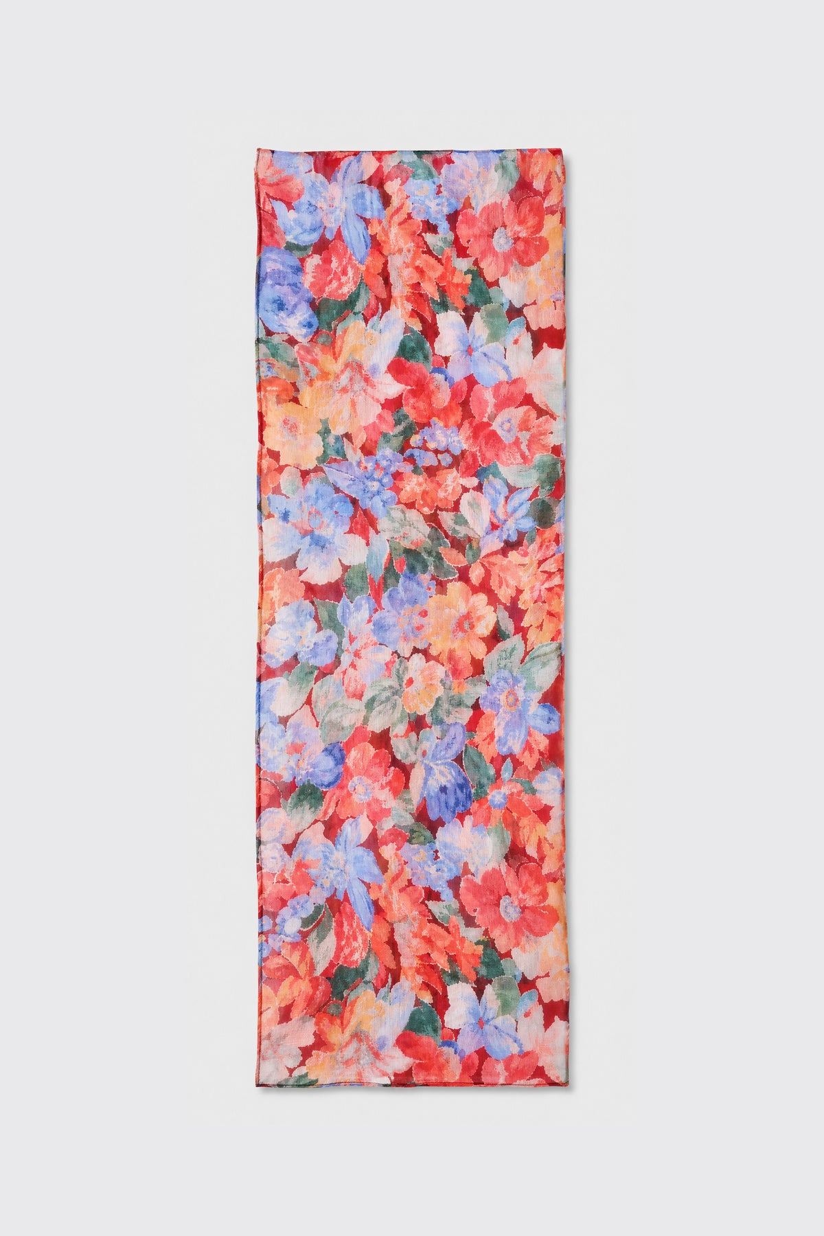 A rectangular scarf named “Julien - Chelsea Floral Red,” featuring a vibrant floral pattern in red, blue, pink, and green hues, is displayed flat on a light gray background.