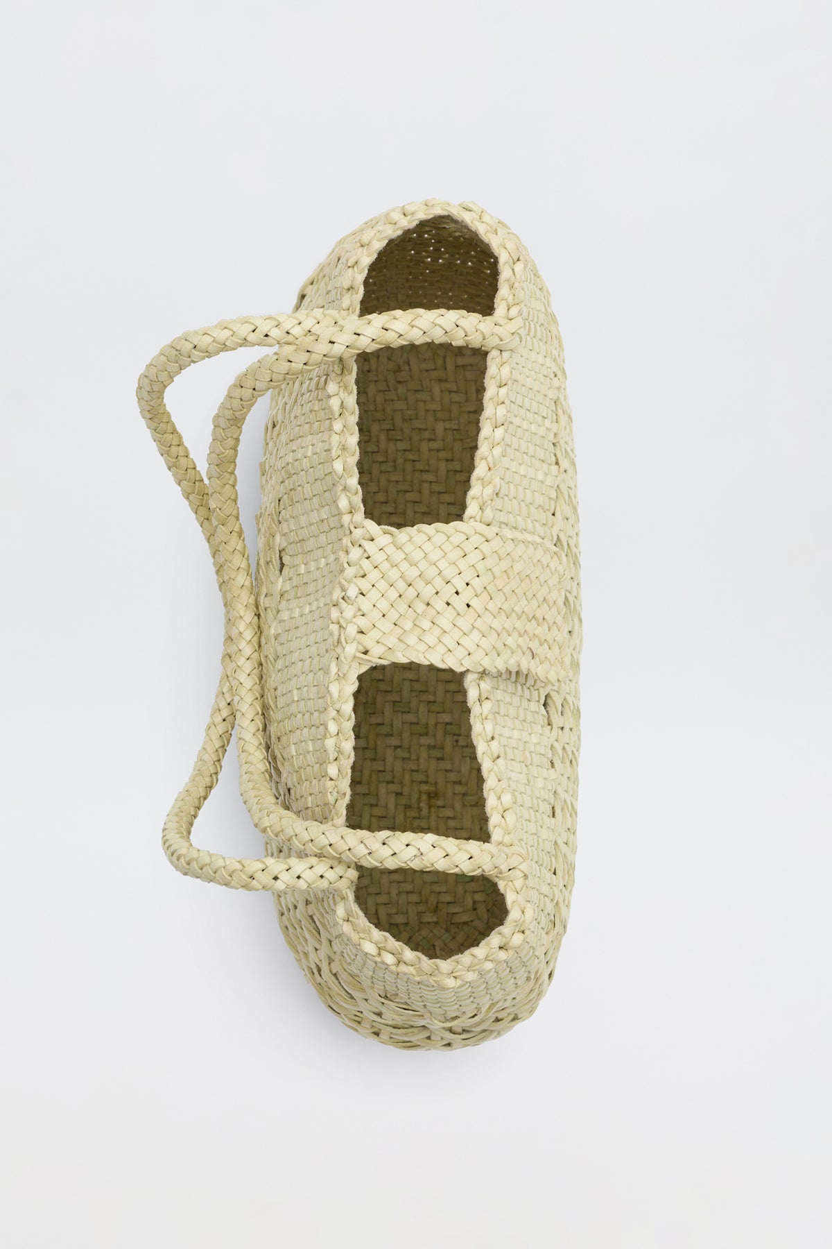 Niamh - Butter, a woven straw basket with two handles inspired by vintage designs, viewed from above against a plain white background.