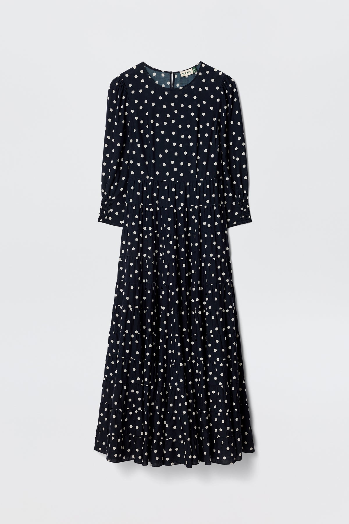 The Kristen - Bohemia Spot Navy is a vintage-inspired, long-sleeved, ankle-length dress in navy with classic spot print, fitted waist, and flared skirt, shown against a plain white background.