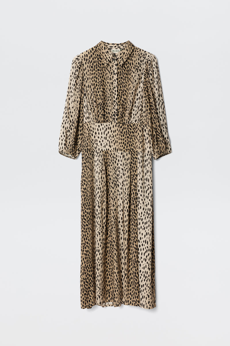 The Izzy - Antelope Spot Black is a long-sleeved, button-up shirt dress with a beige base and black leopard print, pleated skirt, ideal for work or weekends. Displayed on a plain white backdrop.