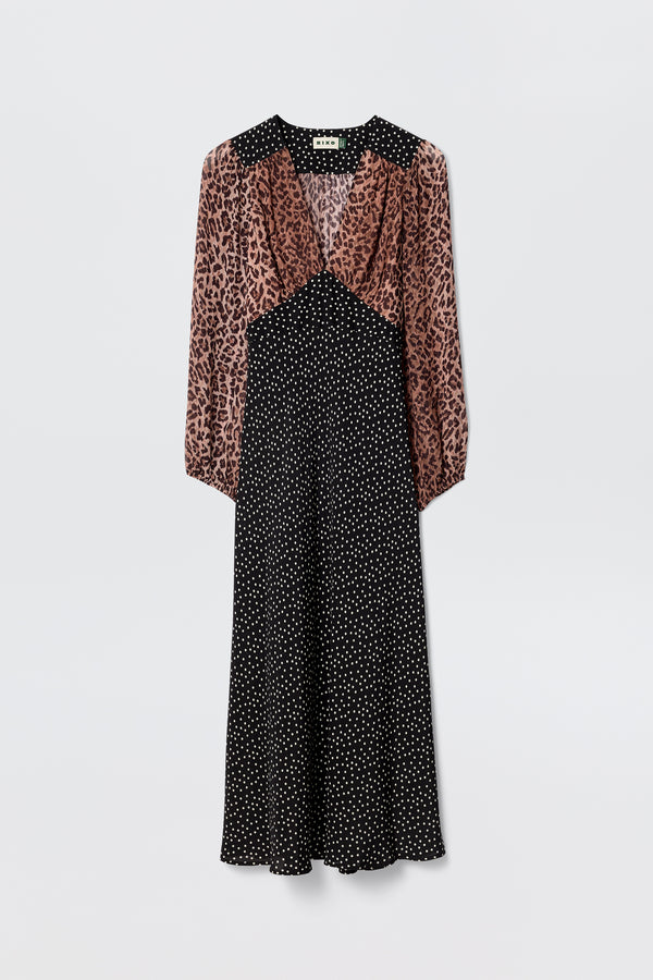The Kaila - Leopard Spot Brown dress blends a brown and black leopard print top with a black polka dot midi skirt, featuring long sleeves, a V-neckline, and a slightly flared hem for a flattering silhouette.
