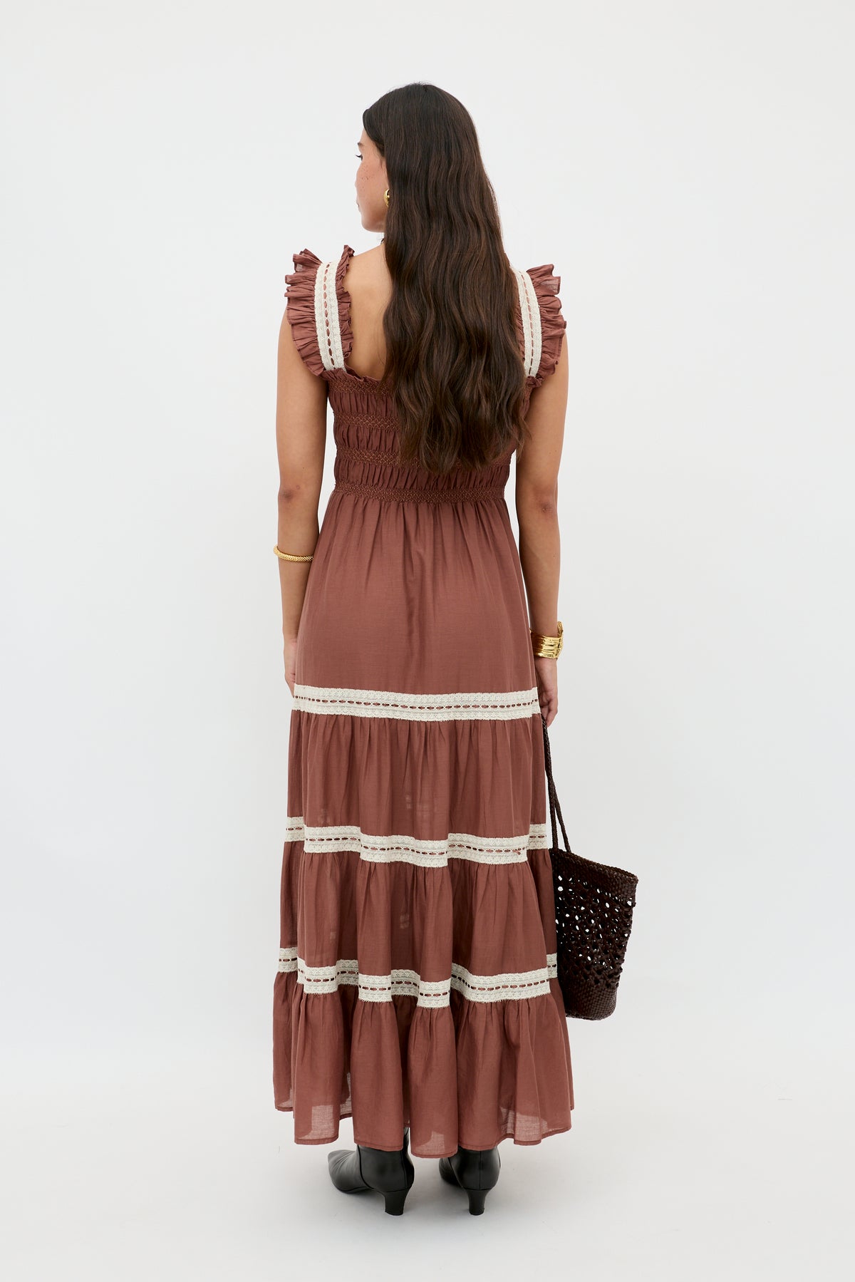 A woman in the Aubrie dress in brown.