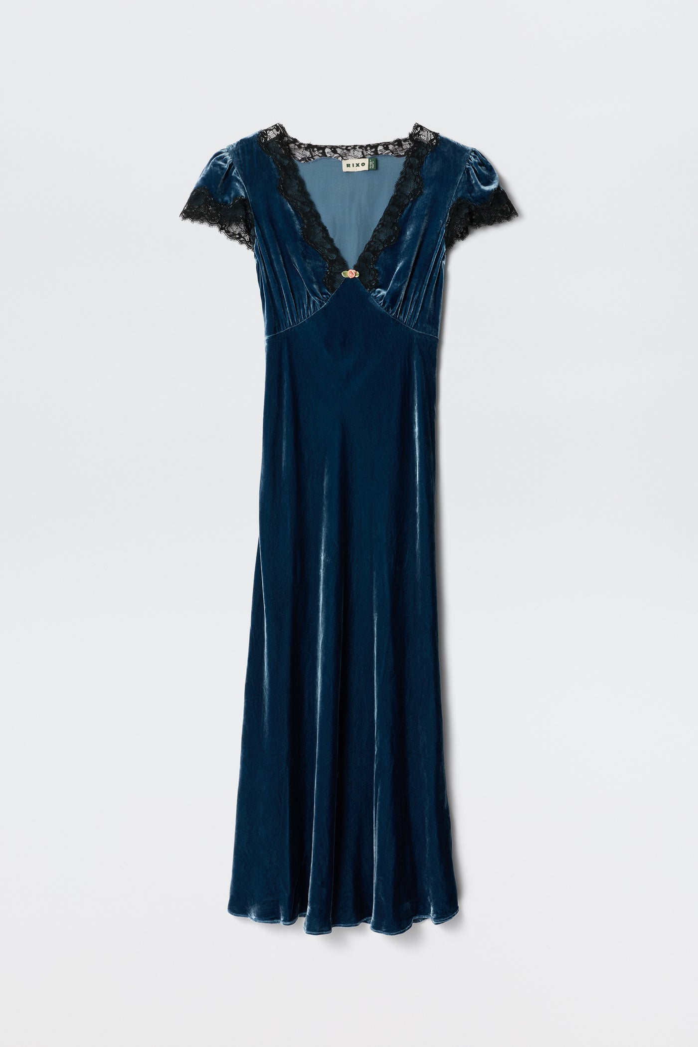 The Clarice - Steel Blue dress features blue velvet fabric, short sleeves, a V-neckline with black lace trim, and a fitted waist. Displayed against a plain white background.