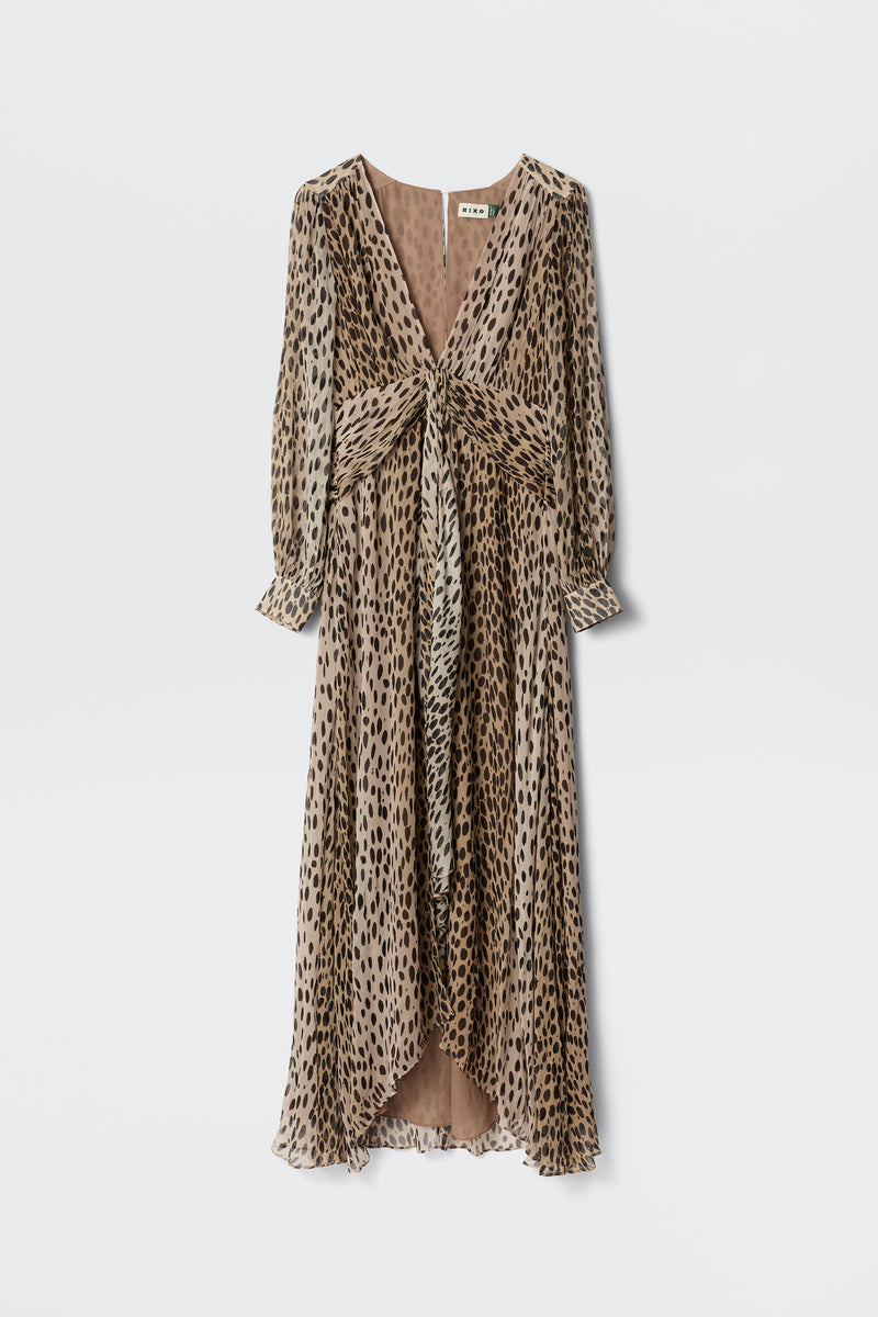 The Meera - Antelope Spot Black gown is a long, flowy dress with a deep V-neckline and long sleeves, crafted from crinkled-chiffon in a brown and black spot print. It features a gathered waist and chic knotted front detail.