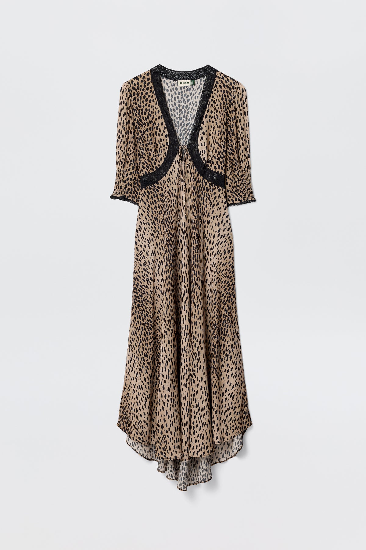 The Amina - Antelope Spot Black dress features a long, flowing silhouette with short sleeves and black lace trims at the neckline, sleeves, and chest, showcasing a brown and black leopard print on a plain white background.