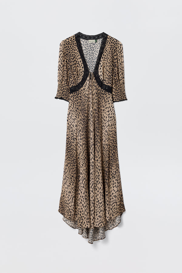 The Amina - Antelope Spot Black dress features a long, flowing silhouette with short sleeves and black lace trims at the neckline, sleeves, and chest, showcasing a brown and black leopard print on a plain white background.
