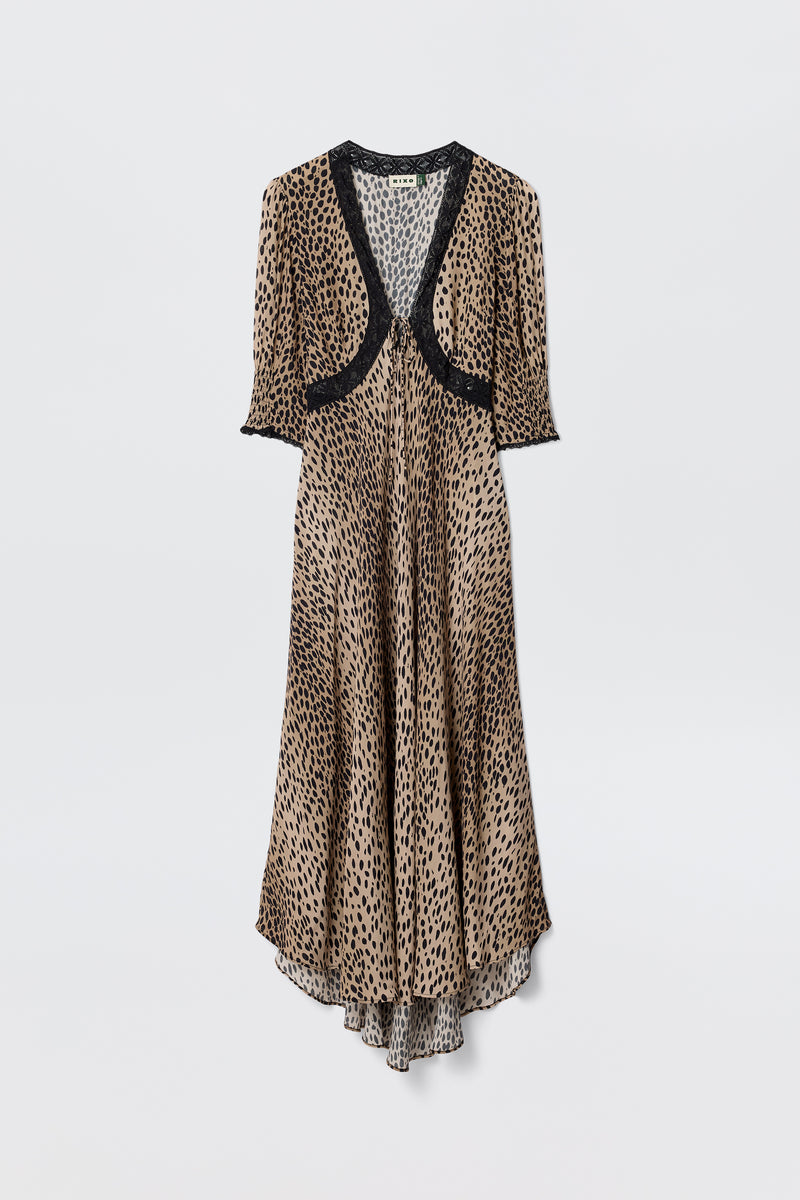 The Amina - Antelope Spot Black dress features a long, flowing silhouette with short sleeves and black lace trims at the neckline, sleeves, and chest, showcasing a brown and black leopard print on a plain white background.
