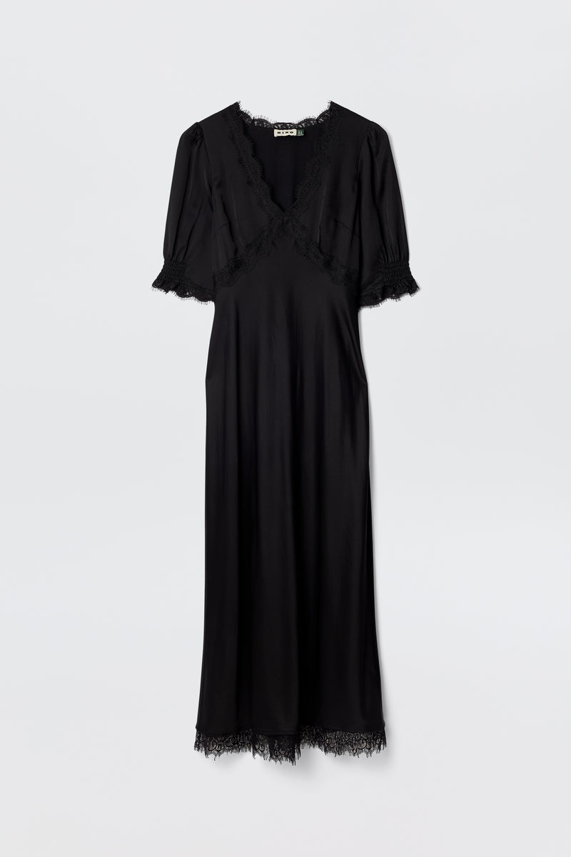 Annina - Black: A bias-cut black midi dress with lace trims on the V-neckline, sleeves, and hem. The short-sleeved, ankle-length silhouette is showcased elegantly against a plain white background.