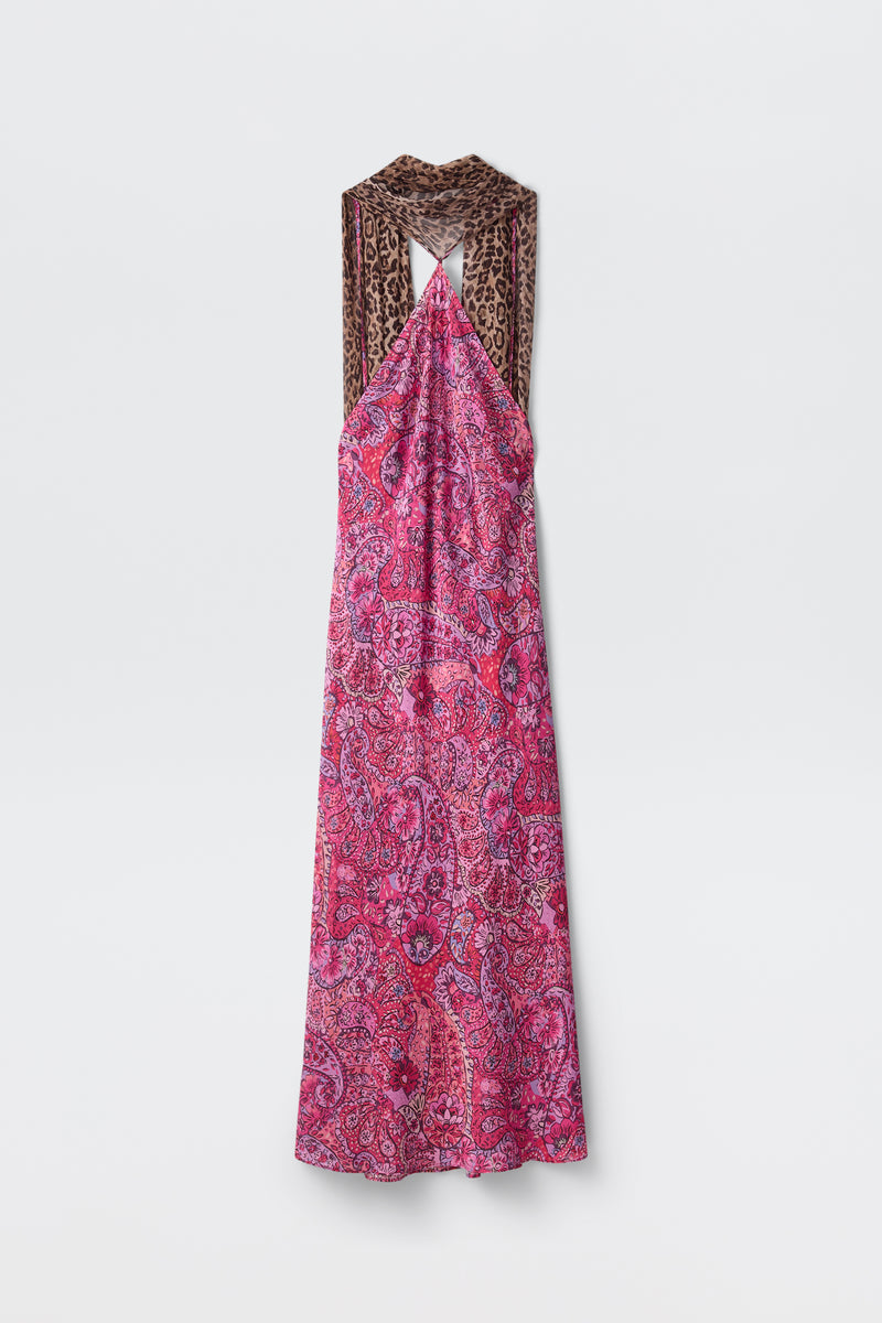 The Hayley - Leopard Paisley Mix Multi is a sleeveless, ankle-length dress featuring a pink and purple paisley pattern with wide, crisscrossed brown leopard print straps, displayed against a plain white background.