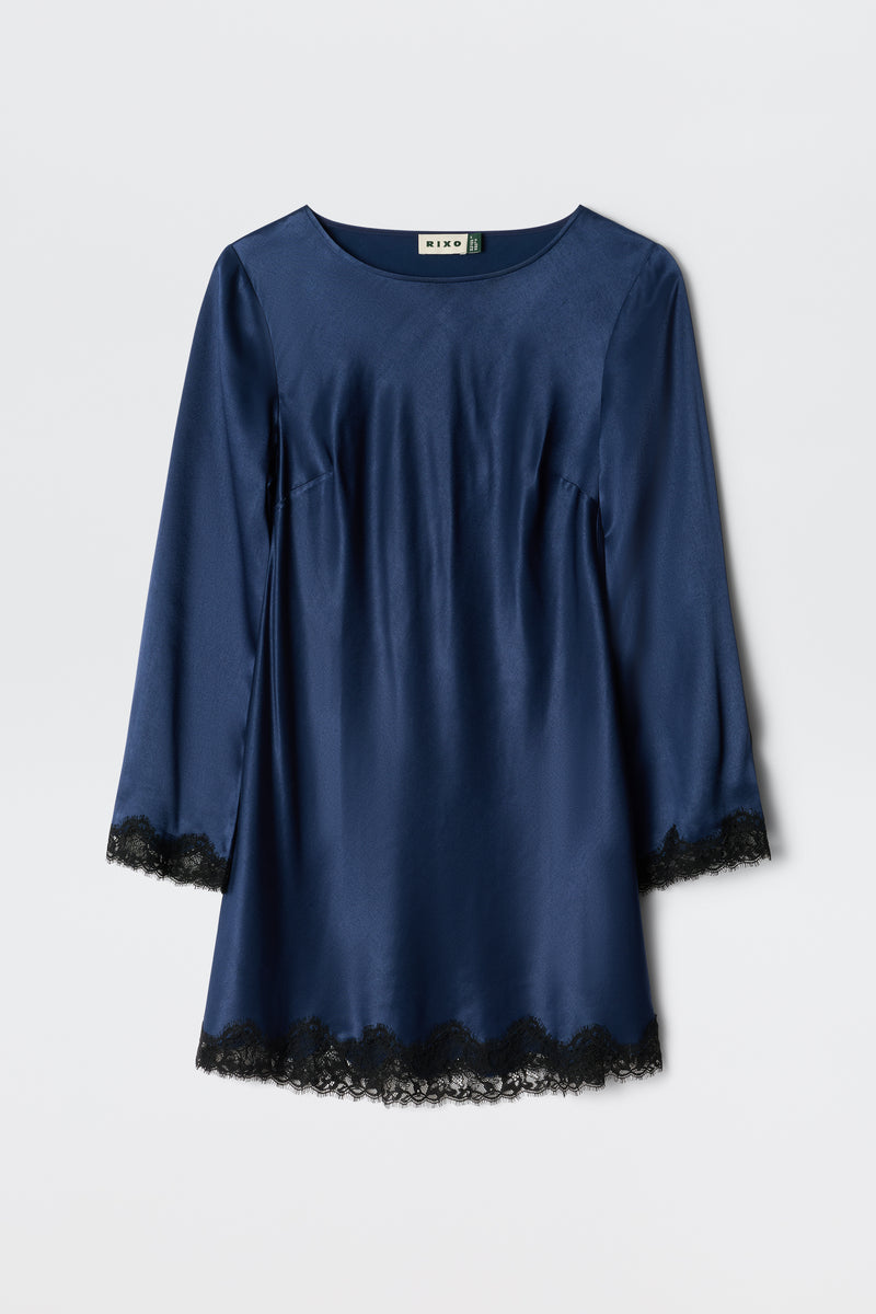 The Ridley - Midnight Navy is a long-sleeved satin dress with black lace trim at the cuffs and hem, shown on a plain white background.