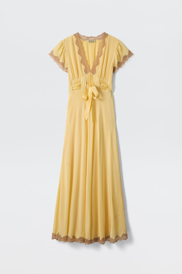 The Marlice - Butter Yellow dress features a long, flowing silhouette with short sleeves, a deep V-neck, brown lace trims, pleated bodice, and waist sash, displayed against a plain white background.