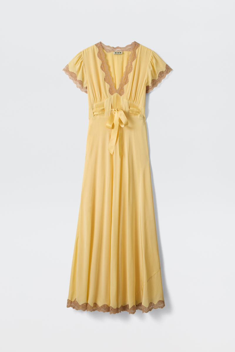 The Marlice - Butter Yellow dress features a long, flowing silhouette with short sleeves, a deep V-neck, brown lace trims, pleated bodice, and waist sash, displayed against a plain white background.