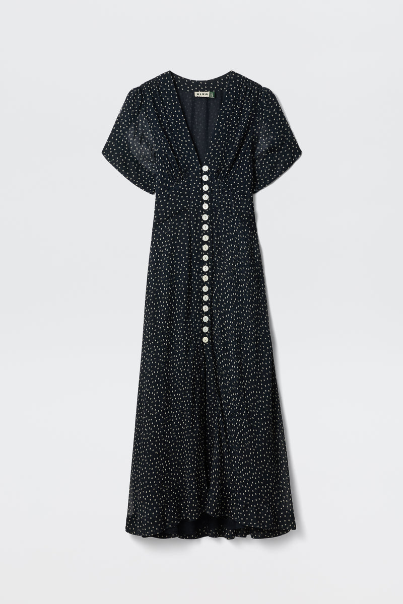 The Novara - Painted Spot Midnight Navy dress features short sleeves, a v-neckline, white polka dots, and large white front buttons for vintage charm.