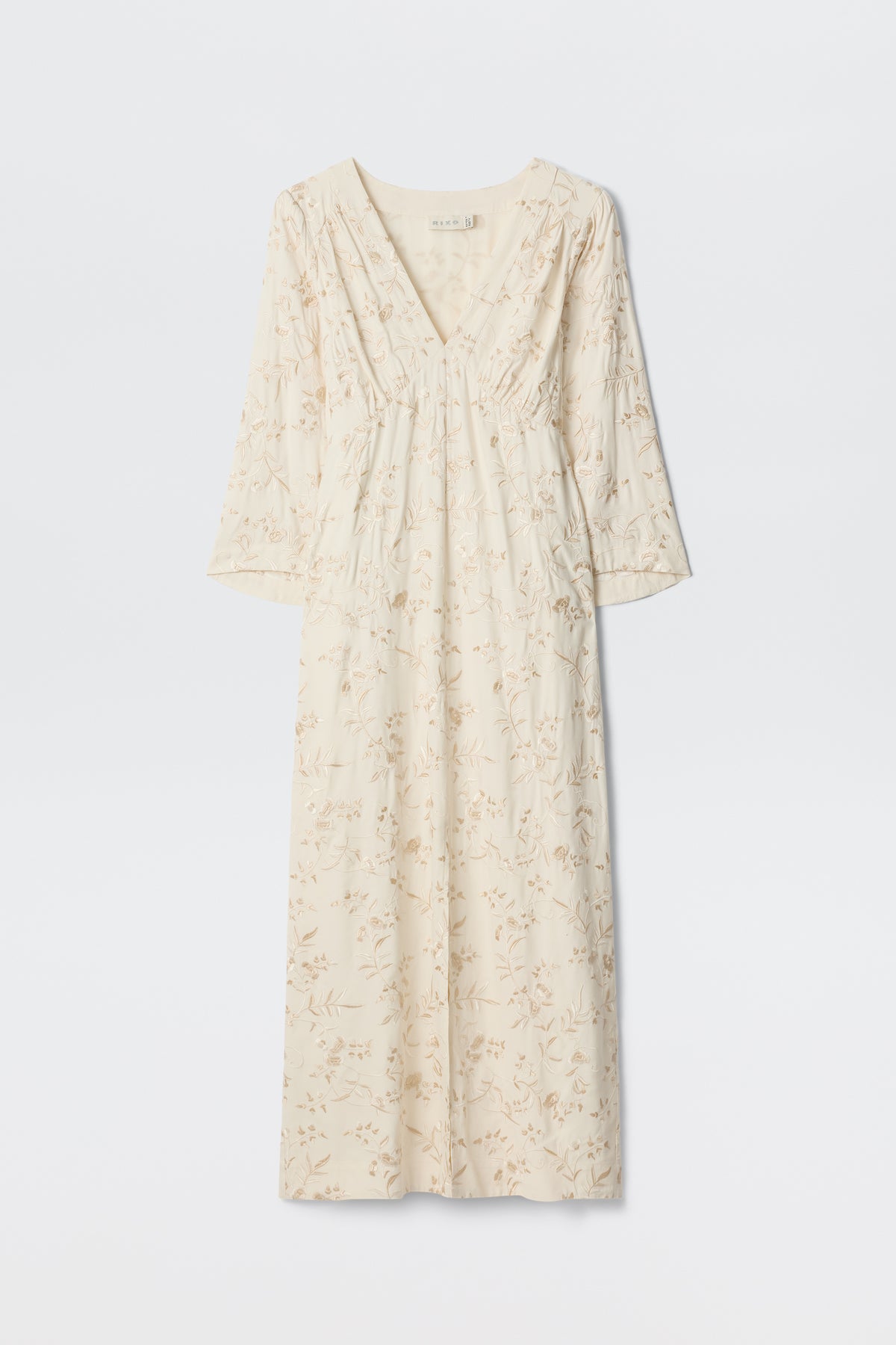 Dahlia - Botanical Embroidery Pearl: A long, cream-colored vintage-inspired dress featuring a subtle embroidered floral design, V-neckline, and long sleeves, displayed against a plain white background.