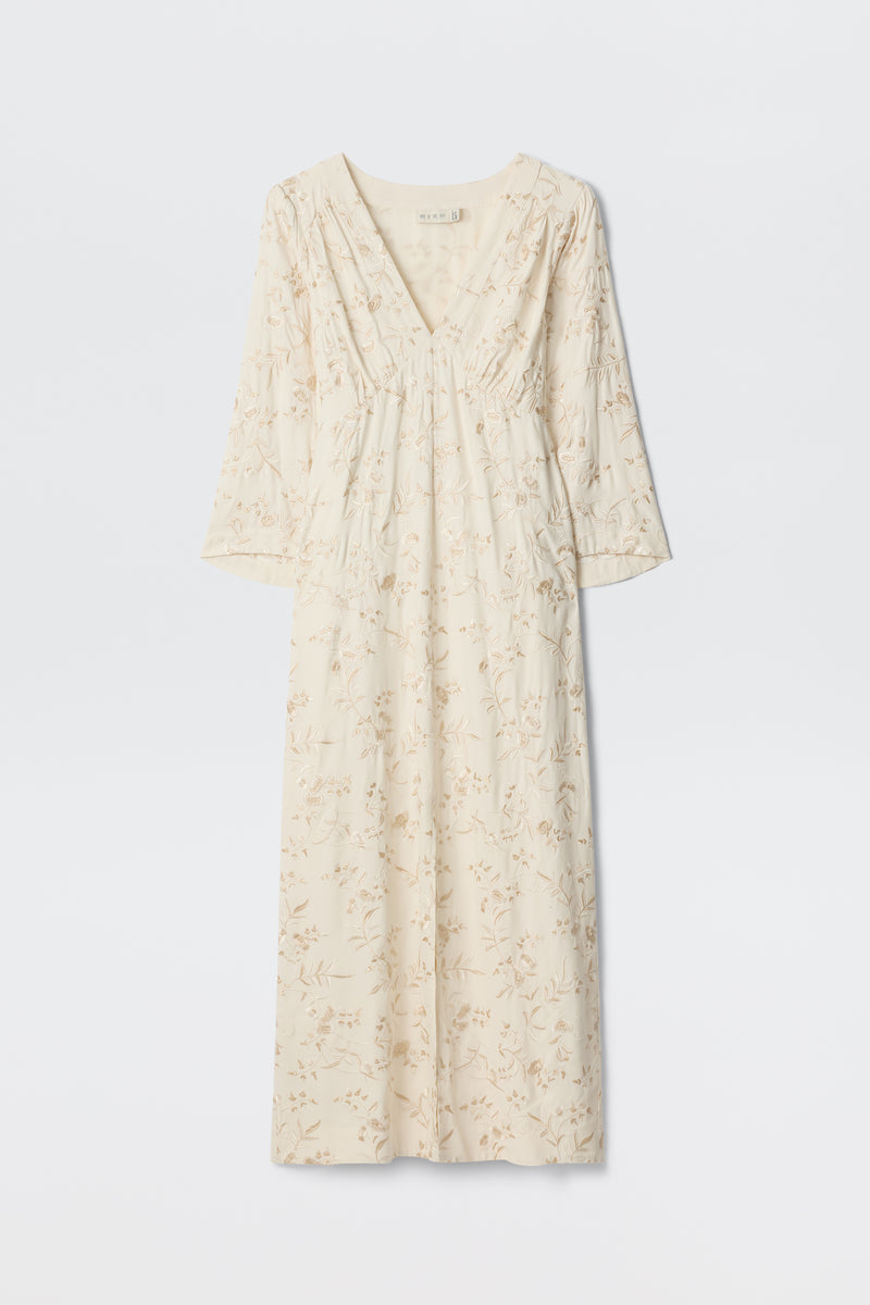 Dahlia - Botanical Embroidery Pearl: A long, cream-colored vintage-inspired dress featuring a subtle embroidered floral design, V-neckline, and long sleeves, displayed against a plain white background.
