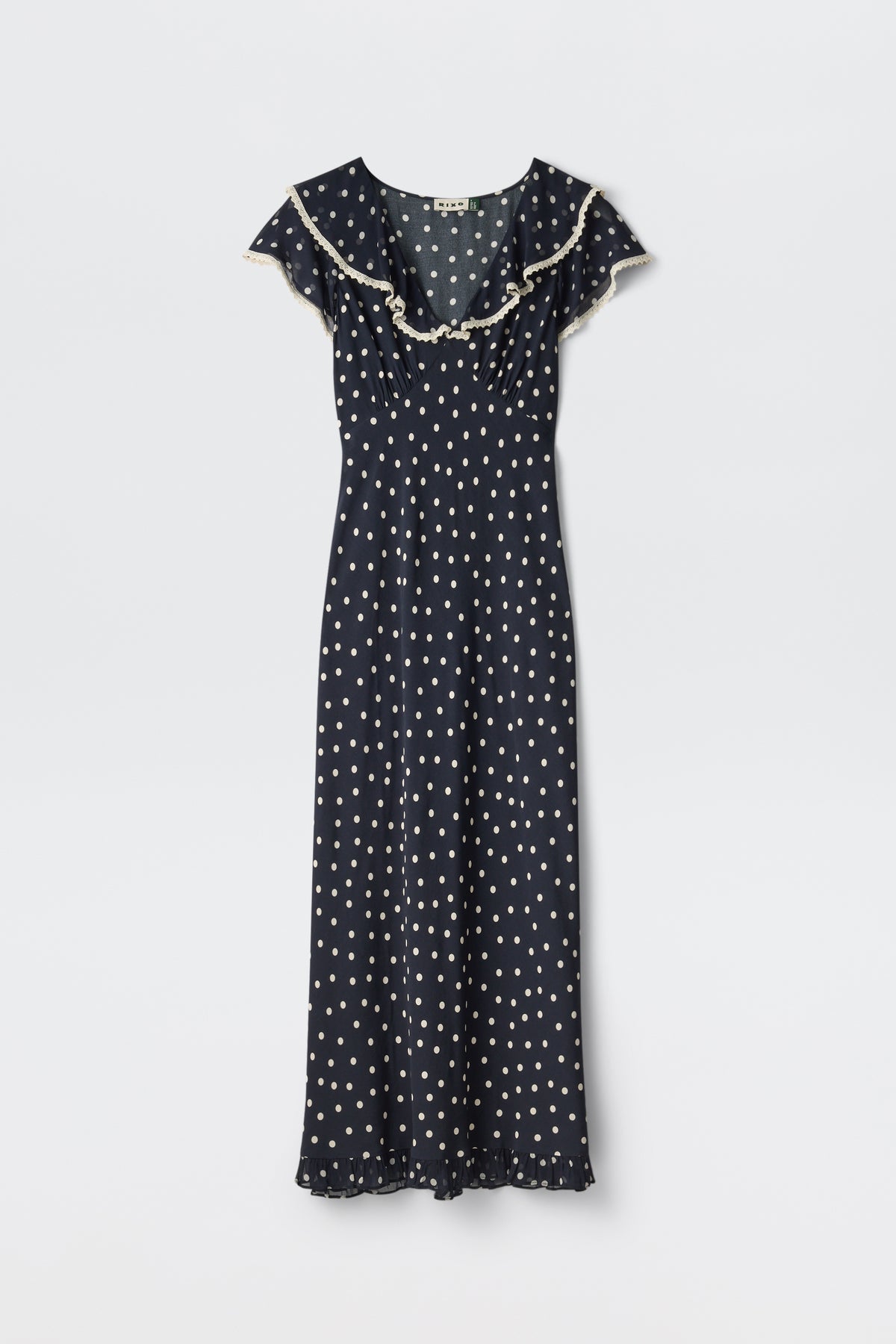 Bethea - Layla Dot Navy: Navy blue short-sleeve maxi dress with white polka dots, ruffled neckline, and hem, shown on a plain white background.