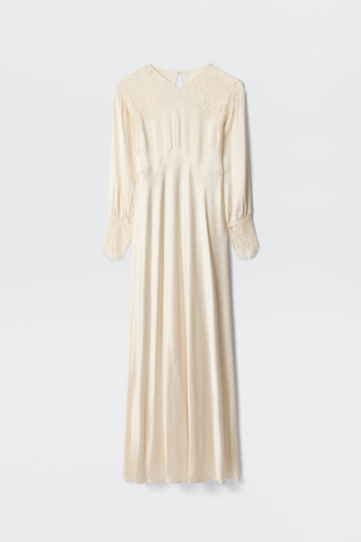 The Axelle - Pearl is an elegant long ivory satin dress featuring lace details on the shoulders and cuffs, long sleeves, and a loose, flowing silhouette. Photographed against a plain white background.