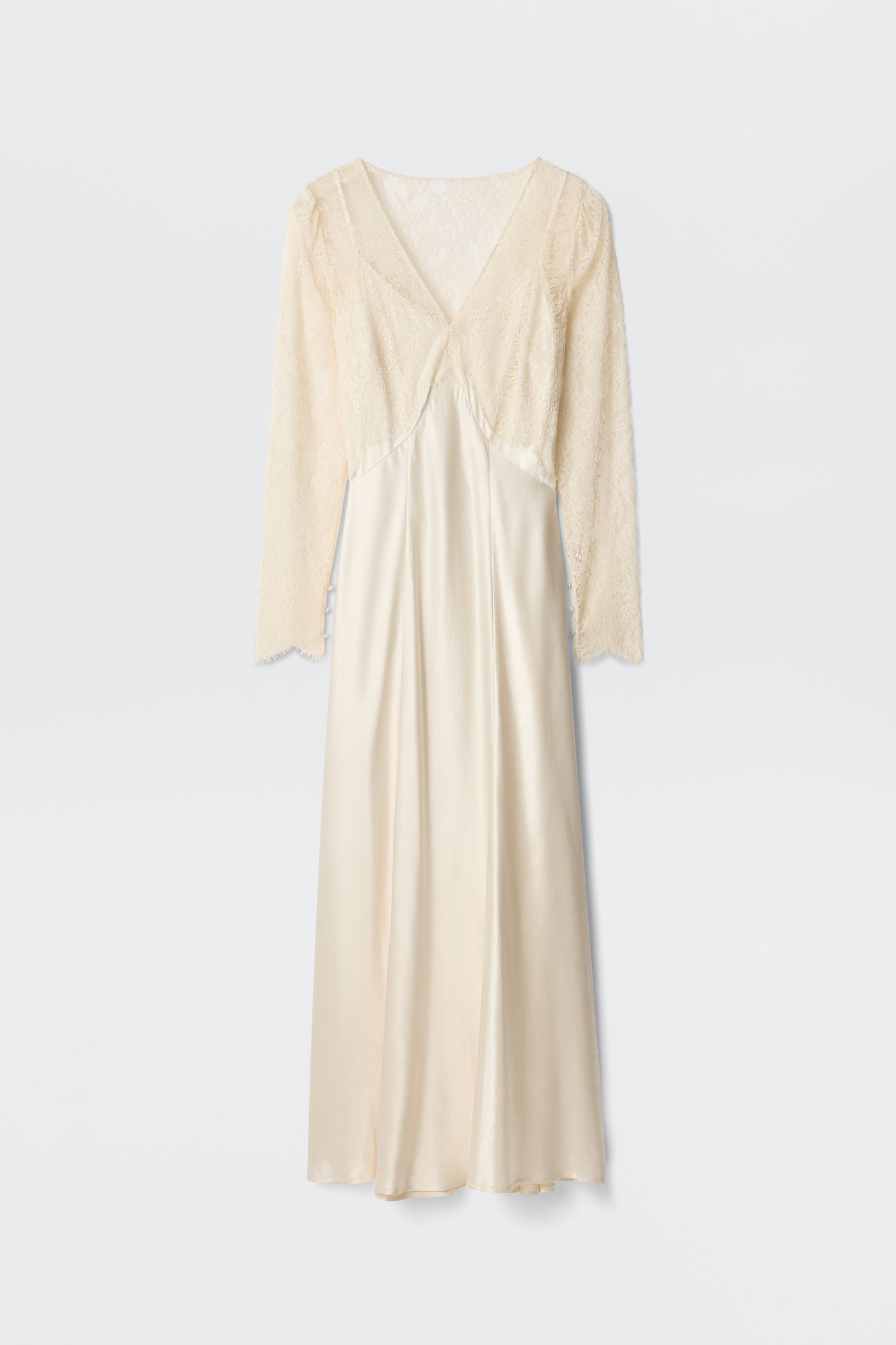 The Laoise - Pearl is an elegant cream-colored long dress with a V-neckline, long lace sleeves, a delicate lace bodice, and a flowing satin skirt with a smooth, shiny finish.