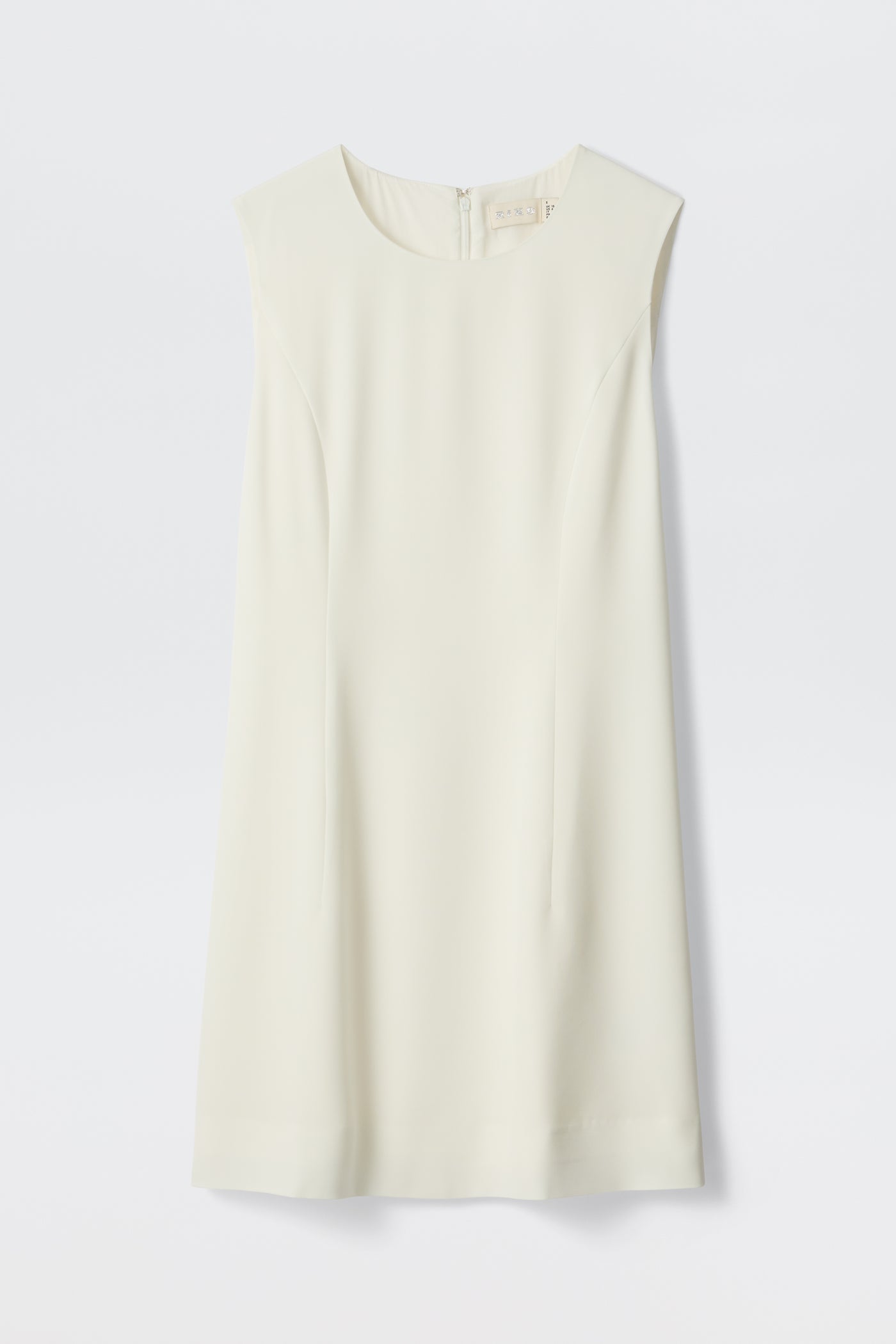 The Katrin - Ivory dress is displayed laid flat against a white background. This sleeveless, knee-length shift dress features a boatneck-inspired round neckline and boasts a minimalist, off-white design—making it an ideal choice for an understated bridal ensemble or special event.