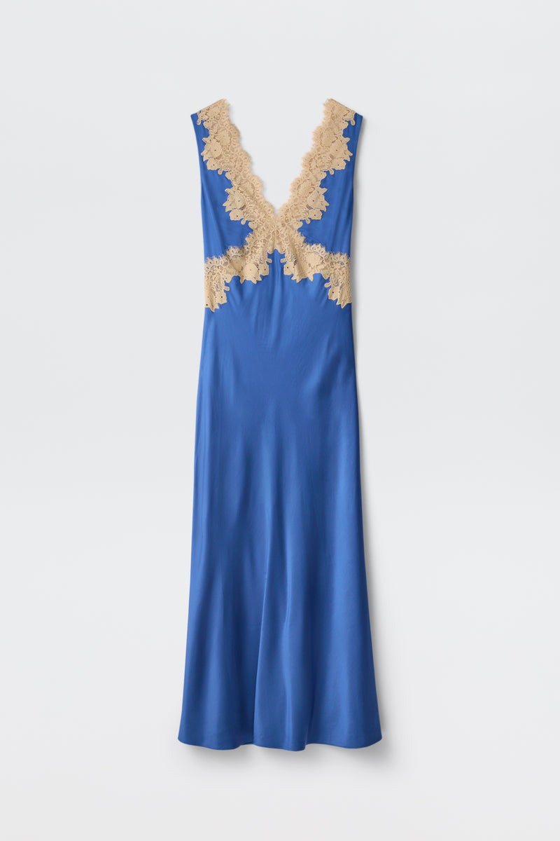 The Lysandra - Iris Blue is a long, sleeveless satin dress in royal blue, featuring a deep V-neckline with beige lace trim at the neckline and waist, presented on a plain white background.