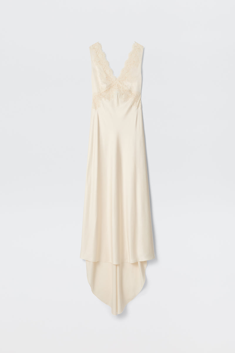Azzurra - Pearl: A sleeveless, ivory vintage slip dress with lace-trimmed V-neckline and bodice, featuring an asymmetrical flowing hem, displayed on a plain white background.