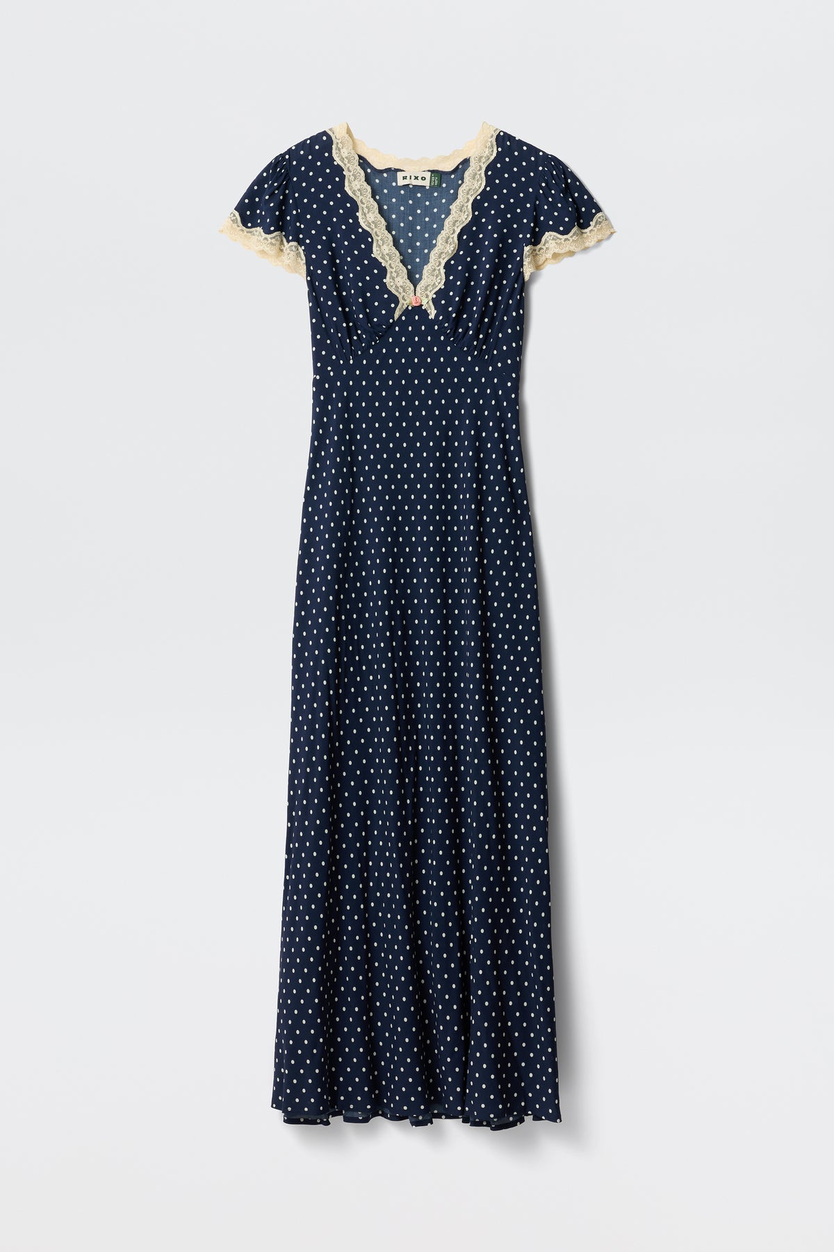 Clarice - Navy Polka Dot: A vintage-inspired, full-length rayon dress with white polka dots, short sleeves, and light beige lace trim on the V-neckline and sleeves, shown on a plain white background.