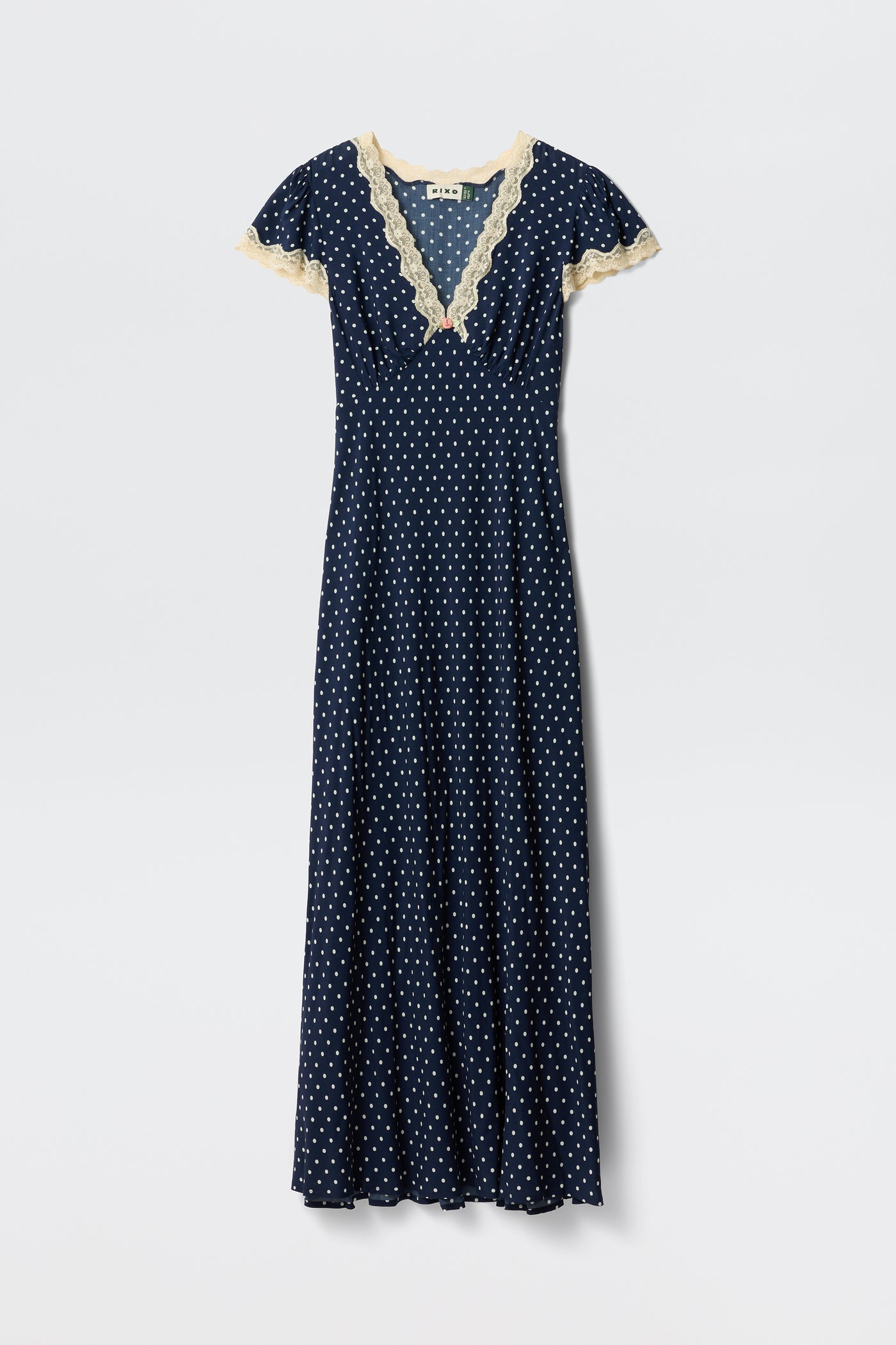 Clarice - Navy Polka Dot: A vintage-inspired, full-length rayon dress with white polka dots, short sleeves, and light beige lace trim on the V-neckline and sleeves, shown on a plain white background.