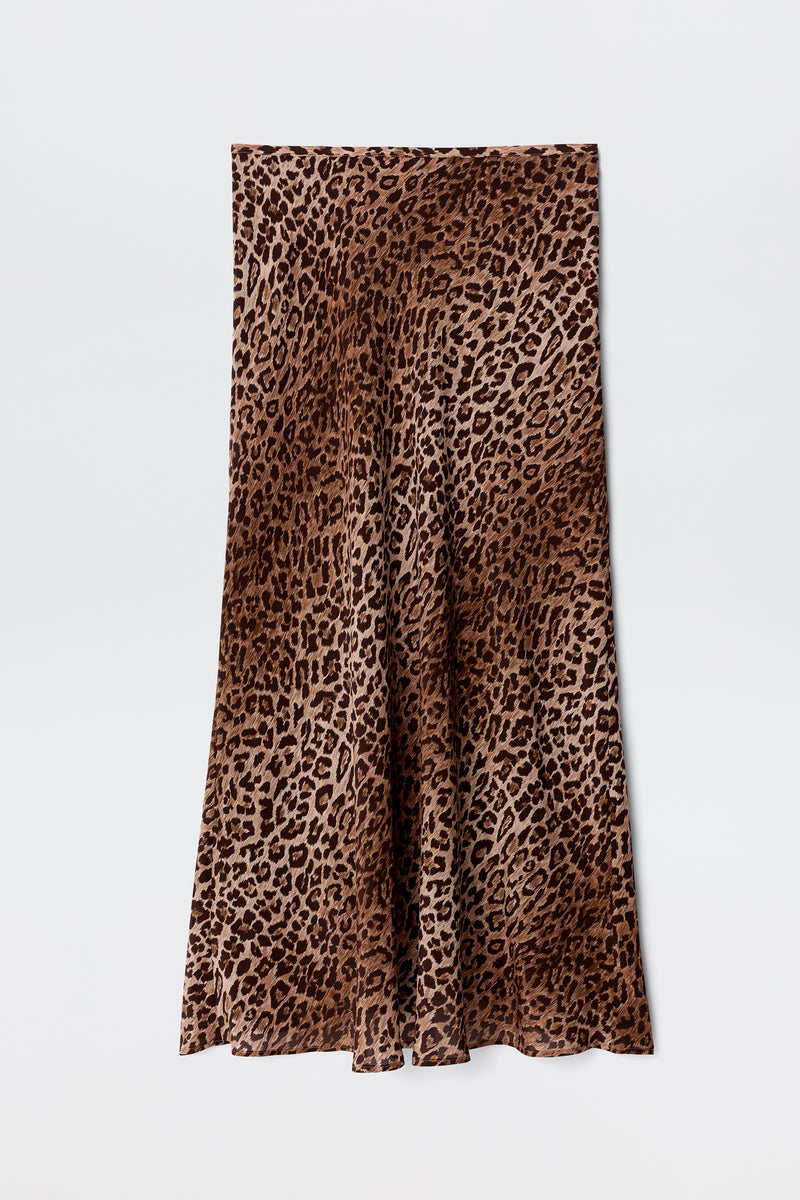 Kelly - Leopard Brown is a long, flared skirt crafted from luxurious silk crepe de chine, showcasing a striking brown and black leopard print pattern and displayed flat against a white background.