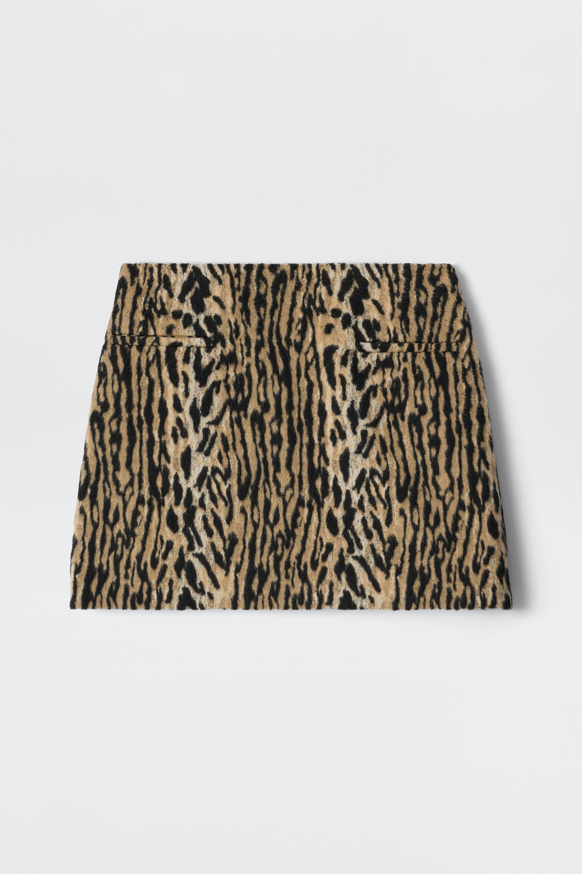 The Mariah - Bohemia Leopard Brown is a high-waisted mini skirt with a bold leopard print in brown, tan, and black, reflecting playful noughties style and shown laid flat on a white background.