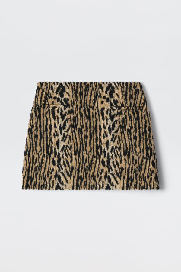 The Mariah - Bohemia Leopard Brown is a high-waisted mini skirt with a bold leopard print in brown, tan, and black, reflecting playful noughties style and shown laid flat on a white background.