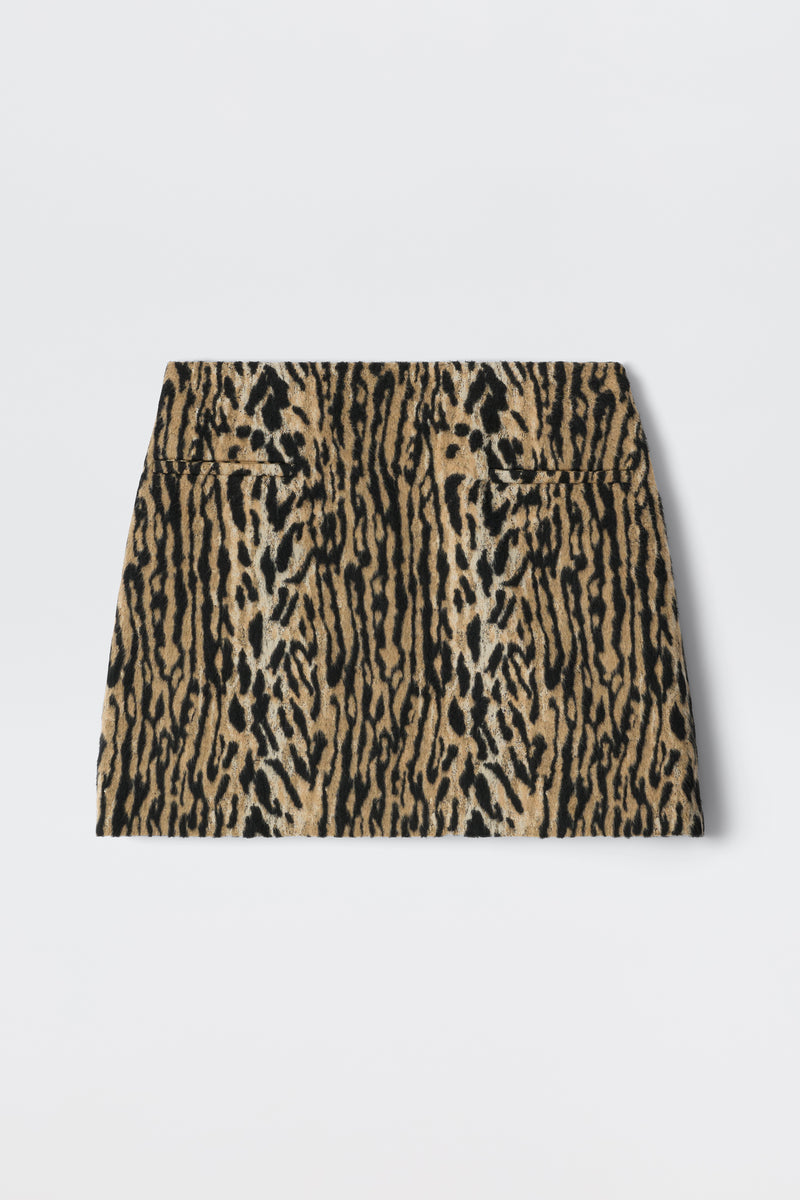 The Mariah - Bohemia Leopard Brown is a high-waisted mini skirt with a bold leopard print in brown, tan, and black, reflecting playful noughties style and shown laid flat on a white background.