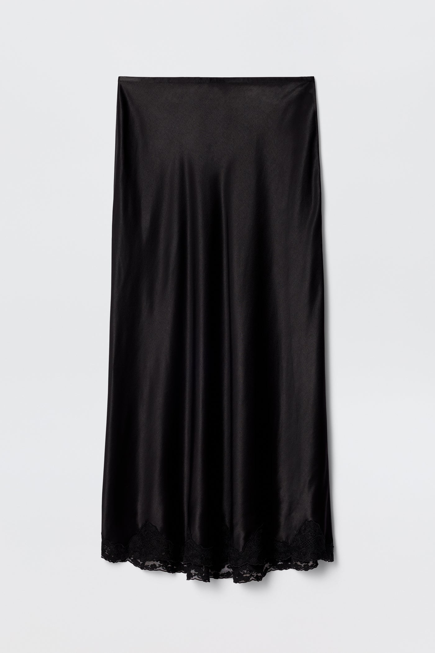The Crystal - Black is a black satin bias-cut midi skirt with a slight sheen and delicate lace trim at the hem, displayed flat on a plain white background.