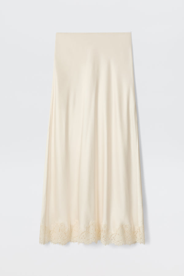 The Matilde - Pearl is a cream-colored satin slip skirt featuring delicate lace trim along the hem, ideal for a bridal look, shown against a plain white background.