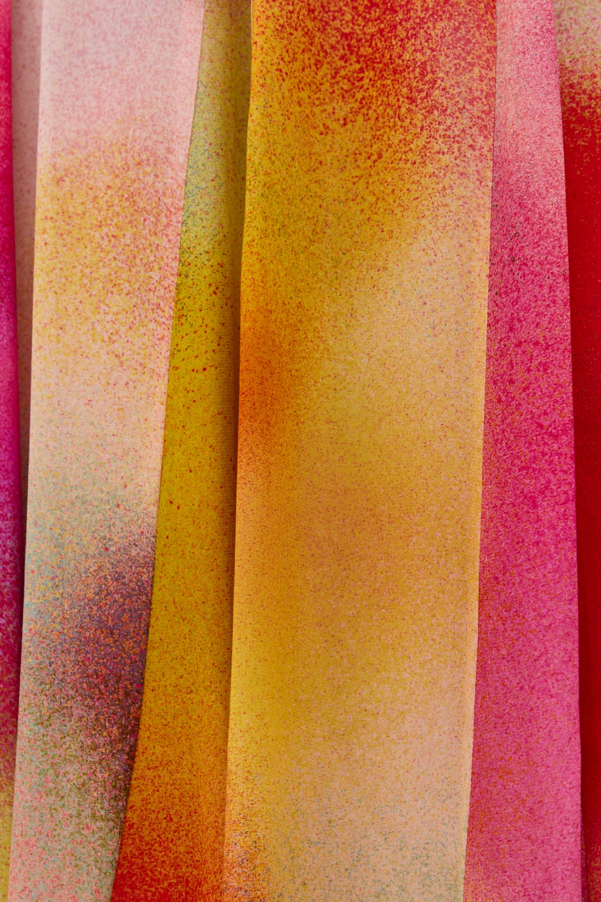Close-up of Billy - Jessica Alexandra Multi, a Liberty fabric featuring vibrant yellow, pink, red, and orange hues with a speckled texture—ideal for spring/summer outfits or a bold midi skirt.