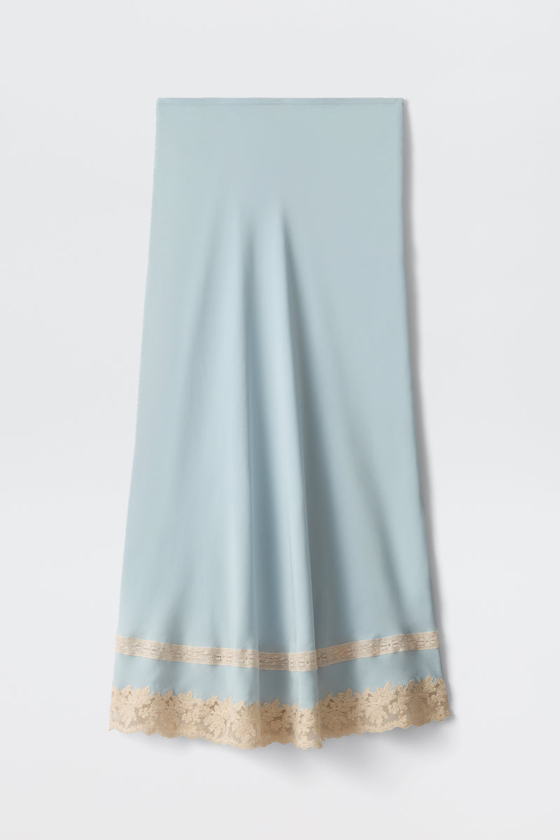 The Costanza - Bluebell is a light blue satin skirt with a beige lace trim at the hem, shown flat on a white background.
