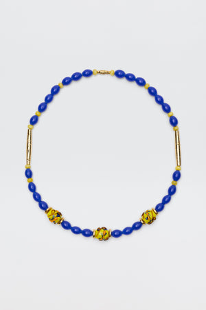 Denali - Multi necklace featuring blue oval beads, three yellow and green patterned round beads, and two gold-plated bead accents, beautifully displayed on a white background.