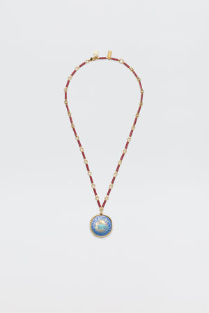 The Ari - Astro Cancer necklace features gold statement disc charms with alternating red and gold links and a round blue-and-gold sunburst pendant. Ideal as a zodiac necklace, it's shown on a plain white background.