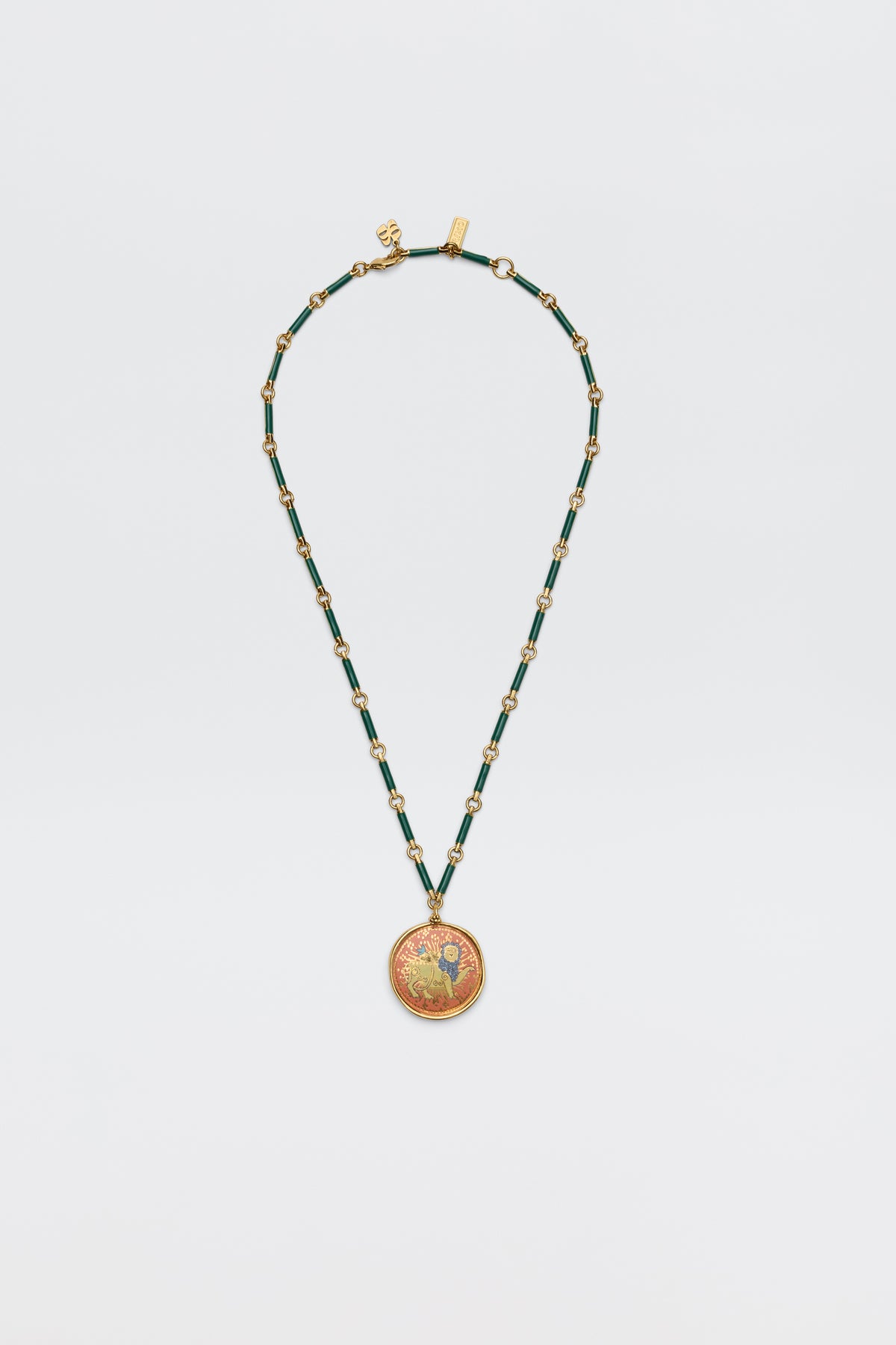 The Ari - Astro Leo necklace features gold and green beads with a circular pendant showcasing a vibrant, intricate design; displayed on a plain white background, this striking zodiac piece brings personality and charm to any look.