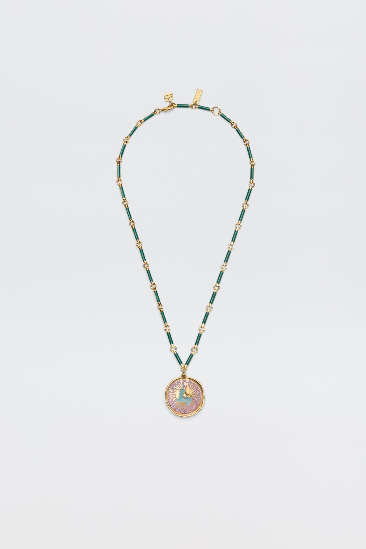 Ari - Astro Sagittarius: A gold and green beaded necklace with an ornate, round pendant featuring an intricate Sagittarius design, shown on a plain white background.