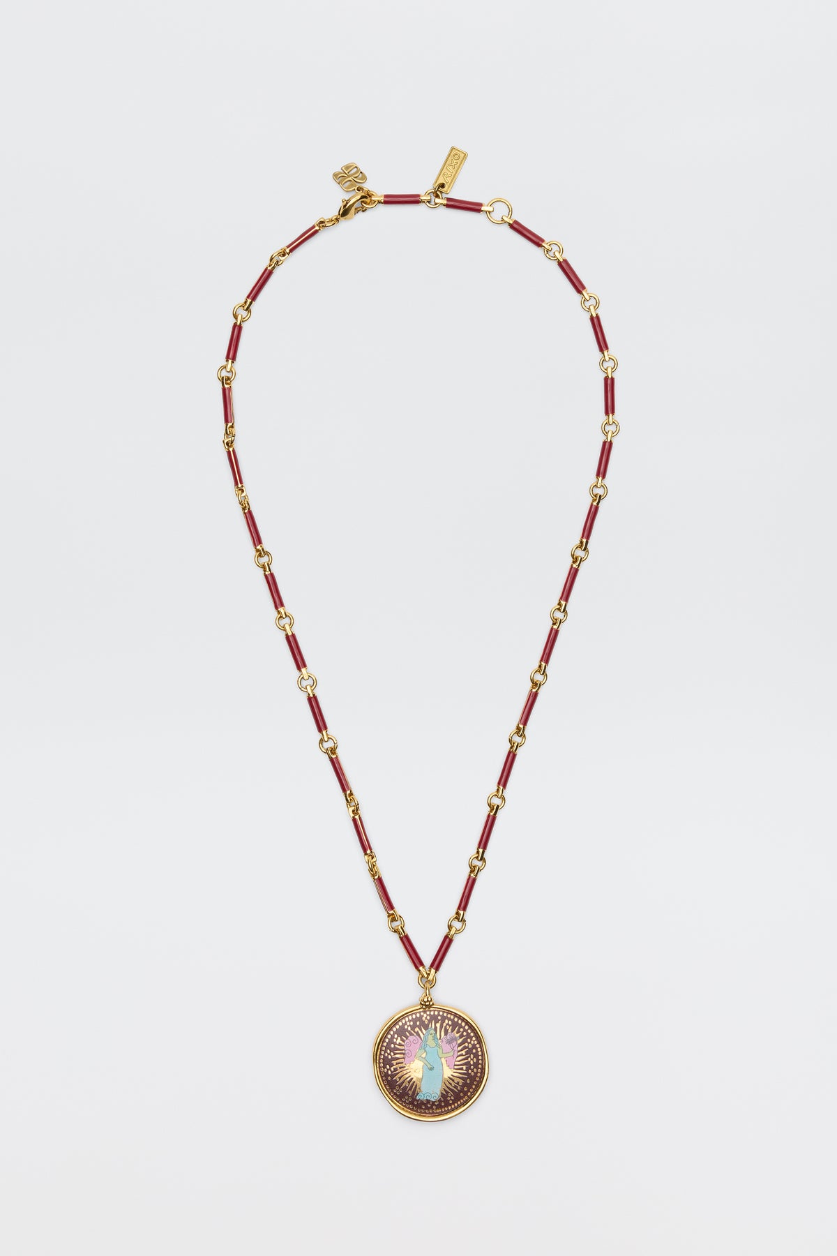 Ari - Astro Virgo: A gold and red beaded necklace featuring a round statement disc pendant adorned with a central opal-like stone, encircled by a purple and gold sunburst design, displayed on a white background.