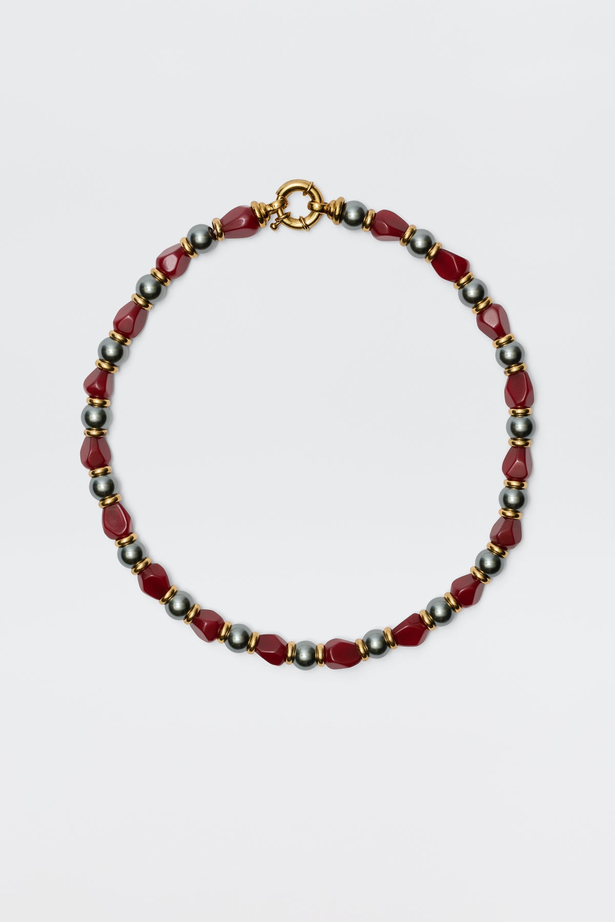 The Palmara - Burgundy necklace features alternating red geometric beads and round metallic silver beads with a gold clasp, showcased on a plain white background.