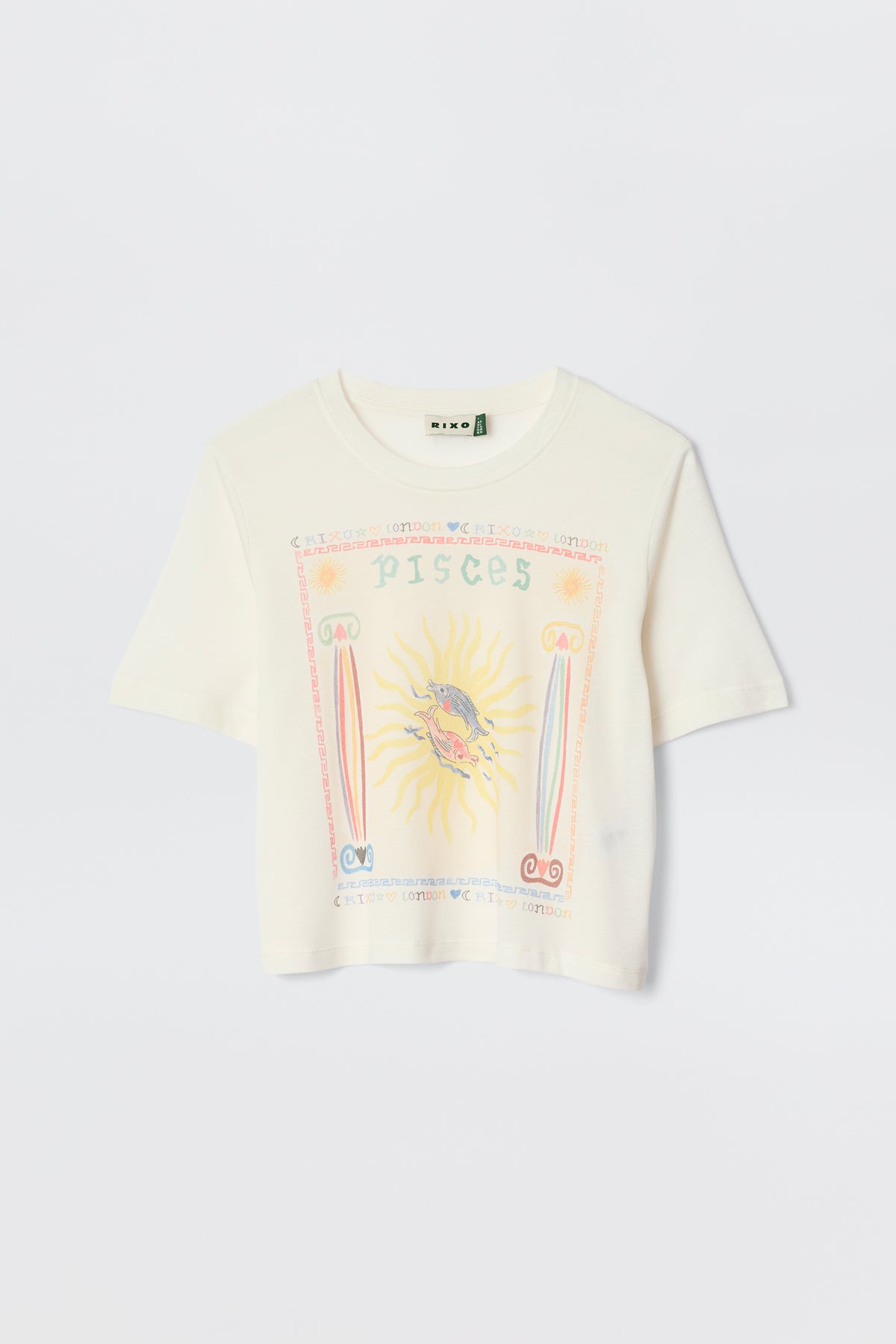 The Ria - Pisces is a white cropped hem T-shirt with a vibrant Pisces illustration—sun and fish at the center, surrounded by pastel astrological symbols and text. Pairs perfectly with RIXO skirts. Displayed against a plain background.