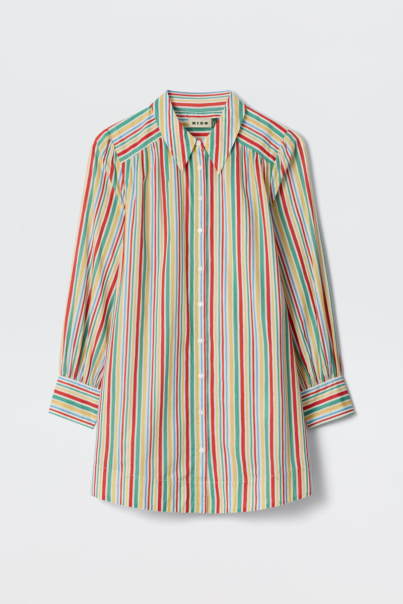 The Ashlynn - Maxime Stripe Ivory is a long-sleeved button-up shirt featuring red, yellow, green, and blue vertical stripes on white, with a collar, cuffed sleeves, and pleated shoulders.