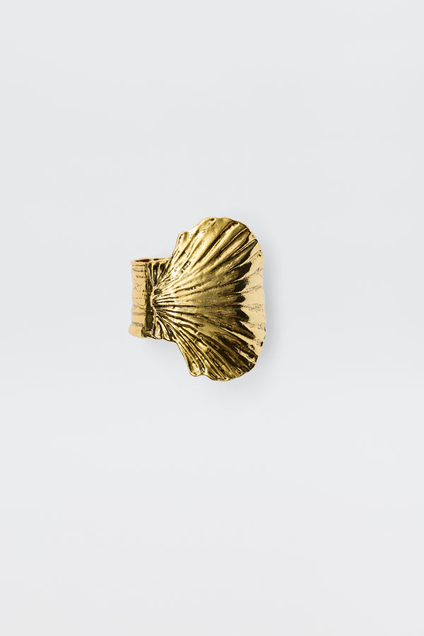 Salene - Gold is a gold ring featuring a textured, fan-shaped shell design, beautifully embodying the essence of shell jewellery on a plain white background.