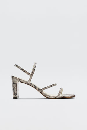 The Ciervo - Snakeskin is a high-heeled strappy leather sandal with an eye-catching snakeskin print, designed with three slim straps over the foot and a sturdy block heel. Shown against a plain white background, it’s the perfect finishing touch for your favorite RIXO occasion wear.
