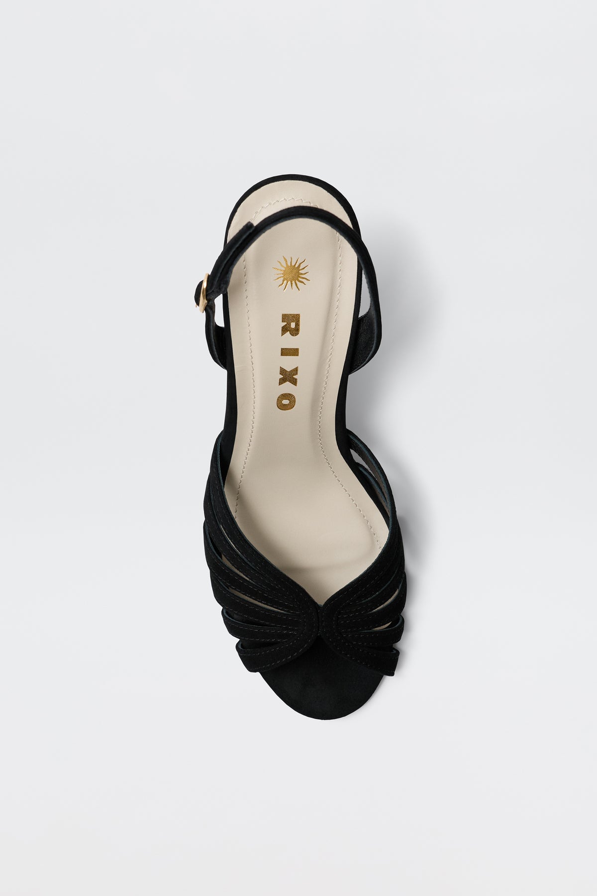 The Mavi - Black sandal is a single black open-toe shoe with a low heel, ankle strap, and knotted front detail. It features a beige insole stamped with RIXO and a gold sun logo near the heel—perfect for any outfit.